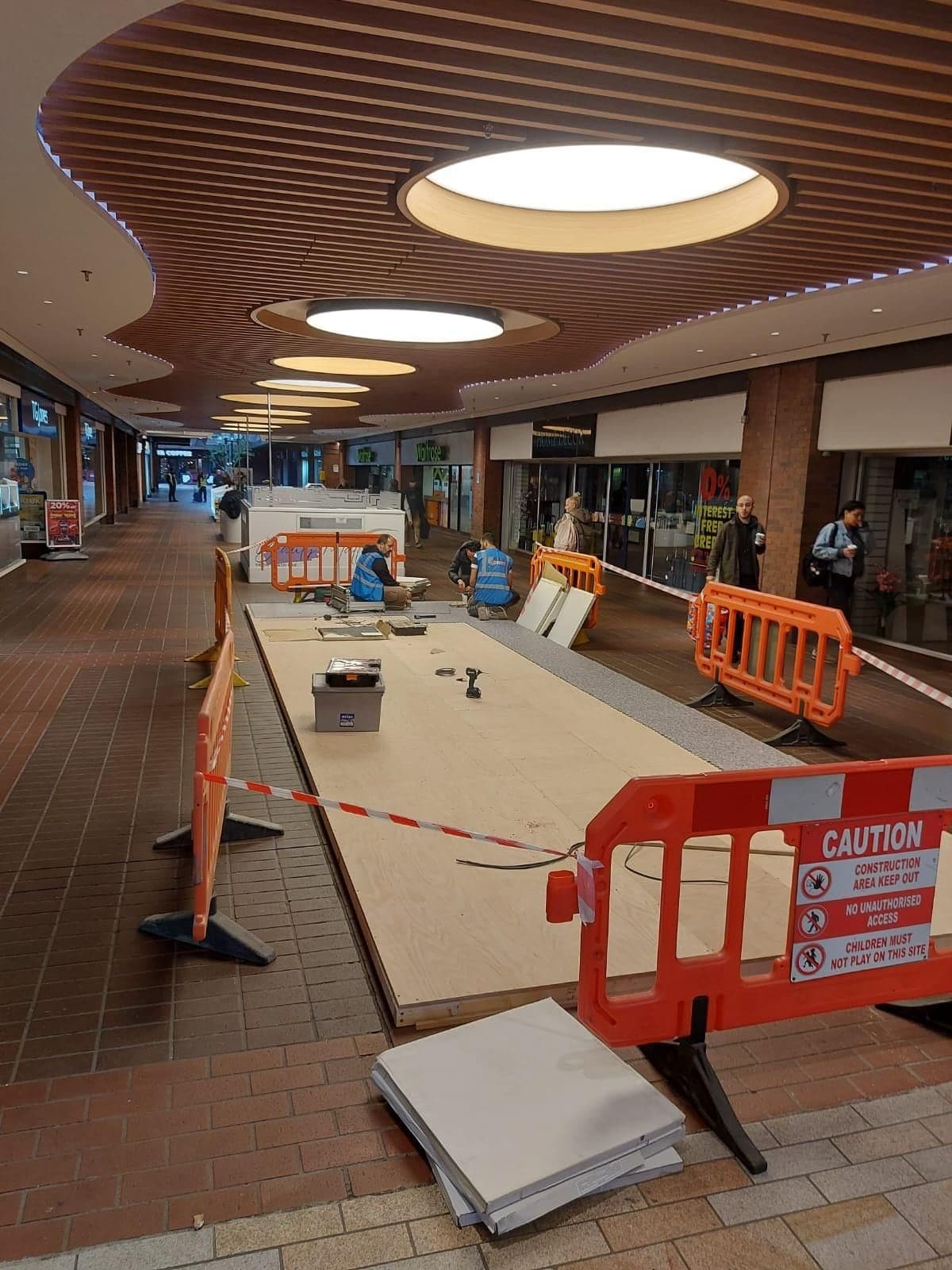 The boarded base of the Freshpoint island unit ready for joinery, with barriers and materials around it