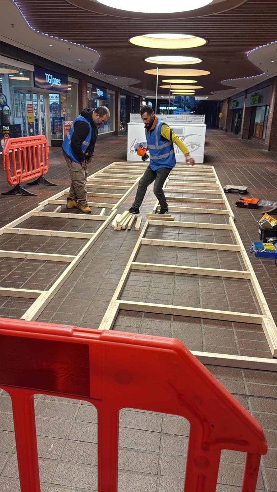 EDYK team laying the timber sub-frame for the Freshpoint island unit on the shopping centre floor