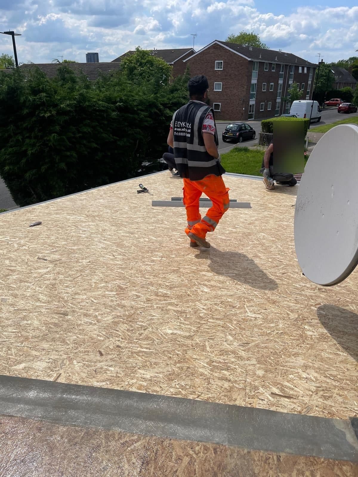 EDYK team on the new roof deck of the house extension, with the boarding laid