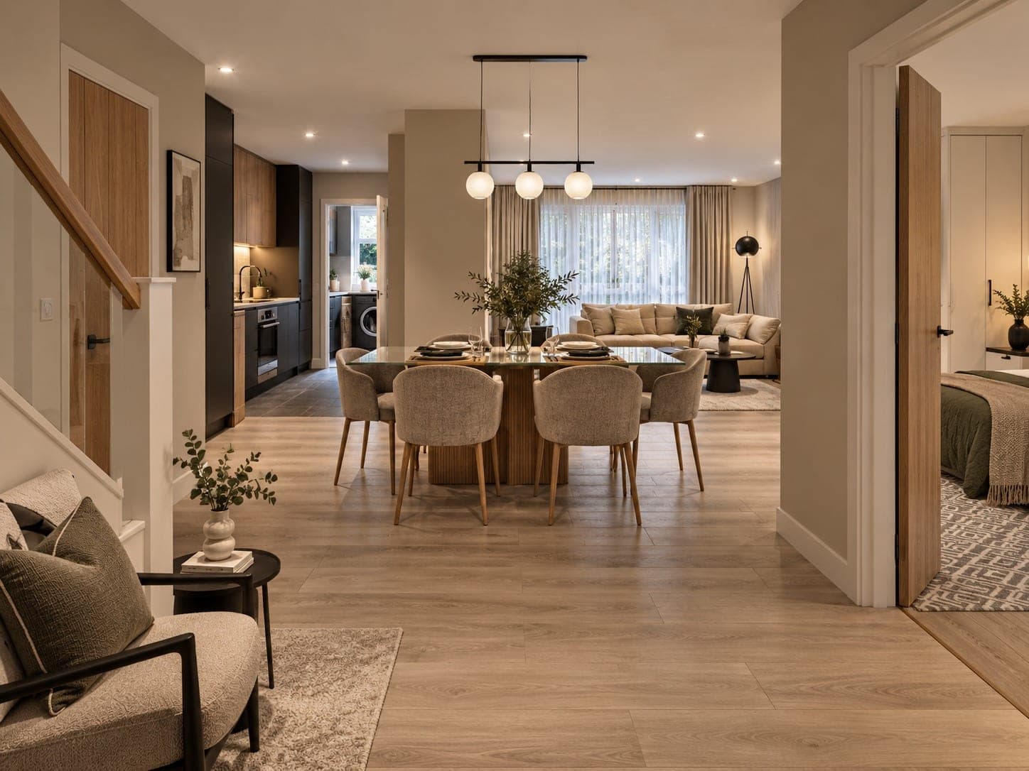 Design visual of an open-plan ground floor with a dining table, kitchen, living area and bedroom door in view