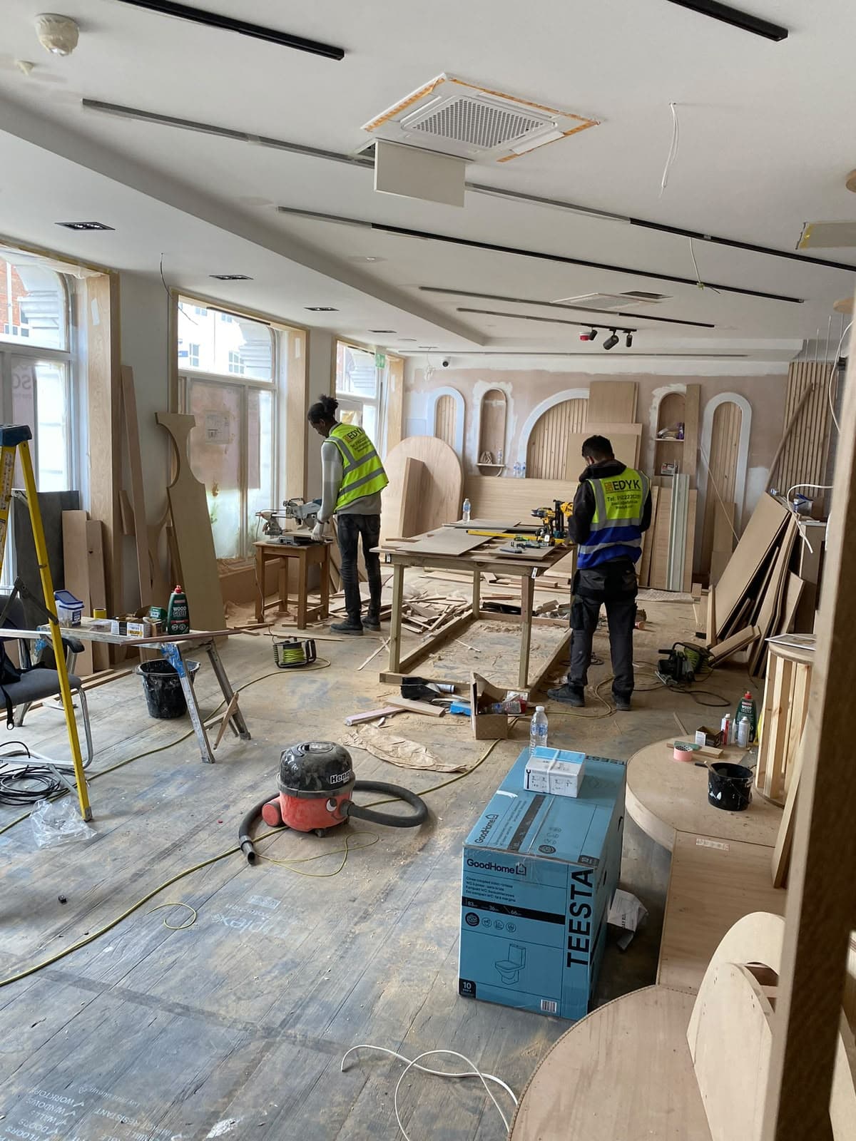 EDYK team cutting and fitting oak panelling during the Lebanese House fit-out